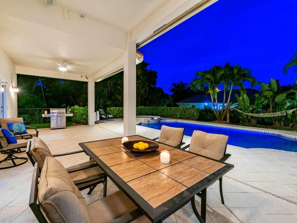 16500 Southwest 62nd Street Southwest Ranches, FL 33331 - Photo 8 of 100 a view of a patio with table and chairs potted plants and palm tree