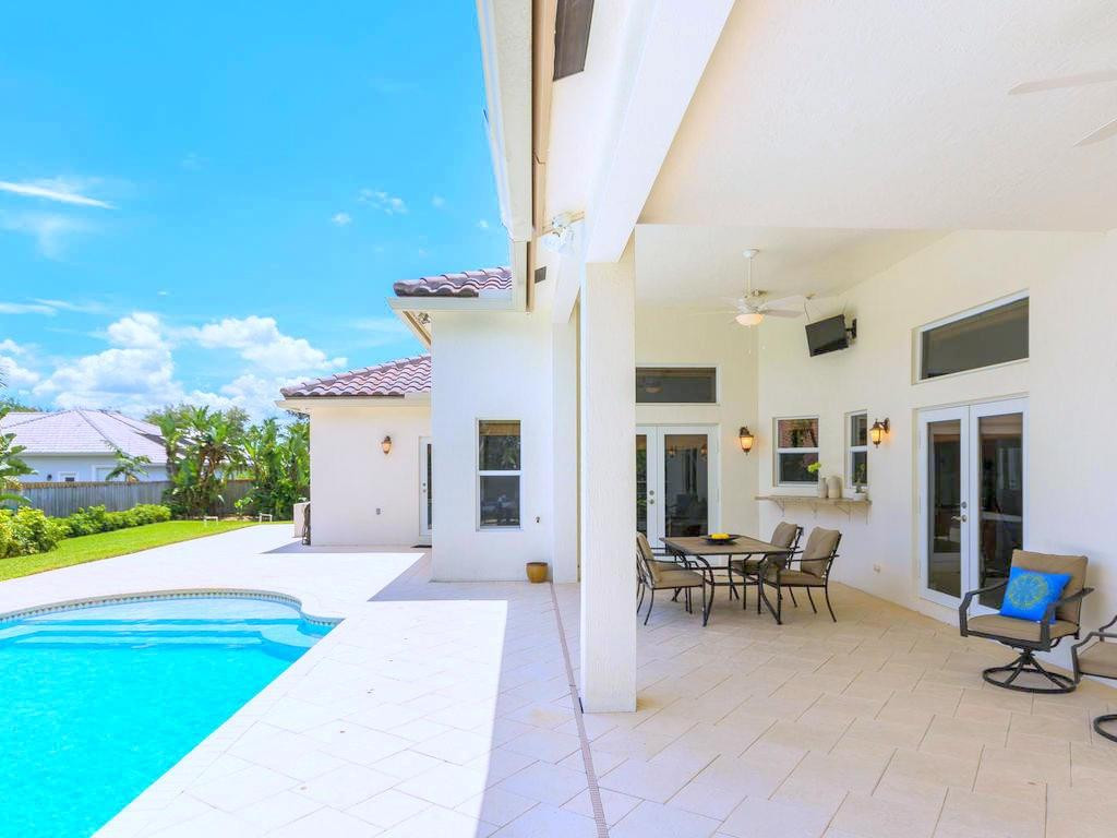 16500 Southwest 62nd Street Southwest Ranches, FL 33331 - Photo 83 of 100 a view of a patio with dining table and chairs with wooden fence and plants