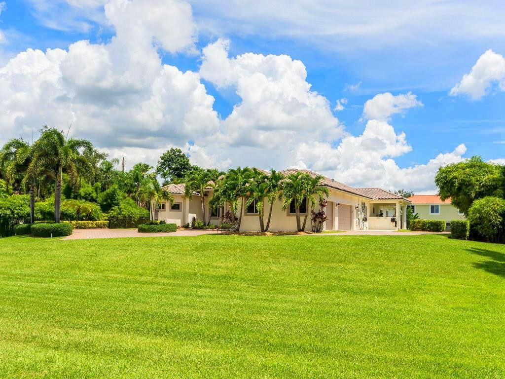 16500 Southwest 62nd Street Southwest Ranches, FL 33331 - Photo 89 of 100 a view of a big yard with palm trees and a yard