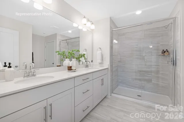 a bathroom with double sink and a mirror