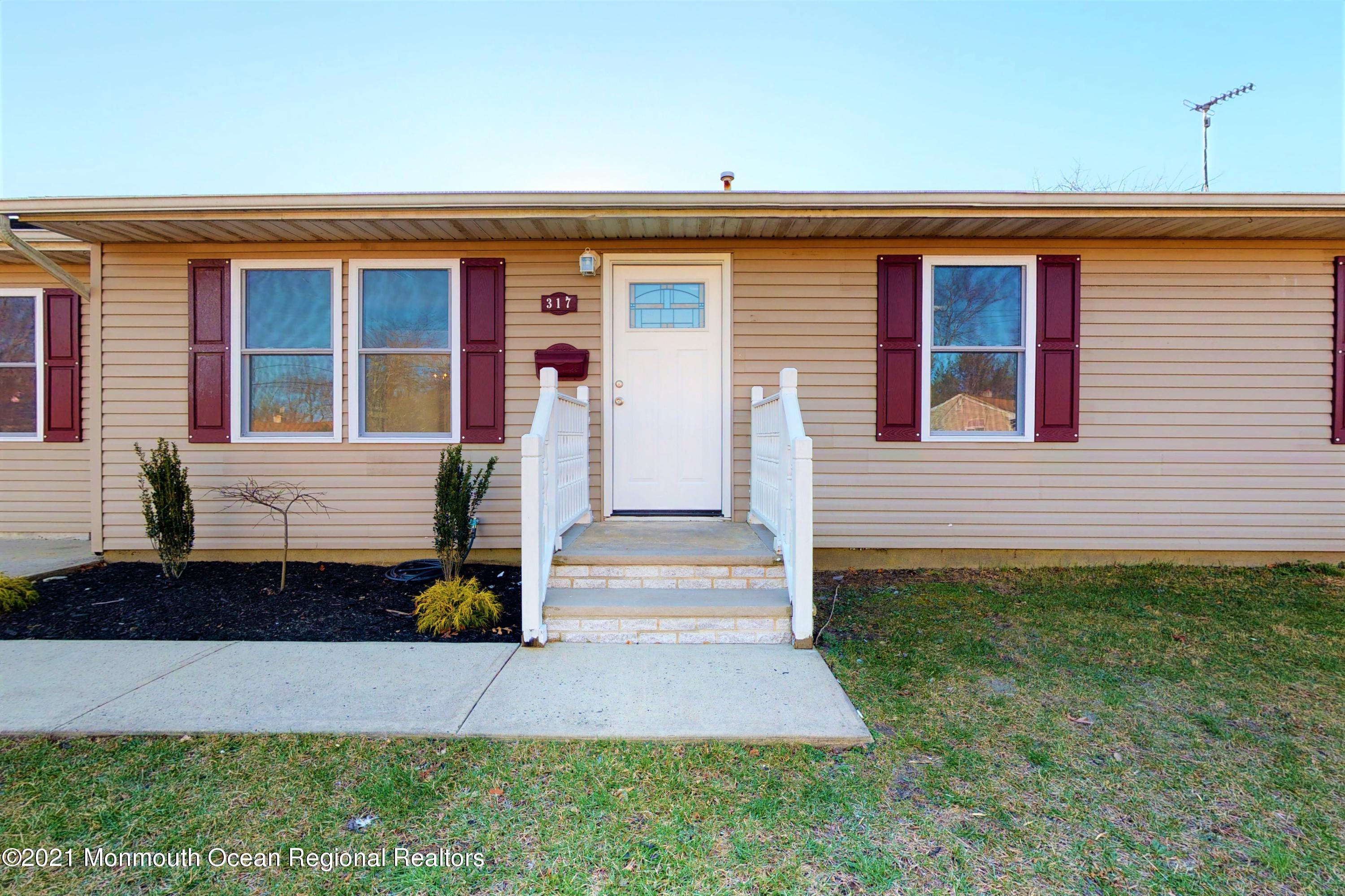 317 Stearman Road Brick, NJ 08723 - Photo 2 of 41 a front view of a house with garage