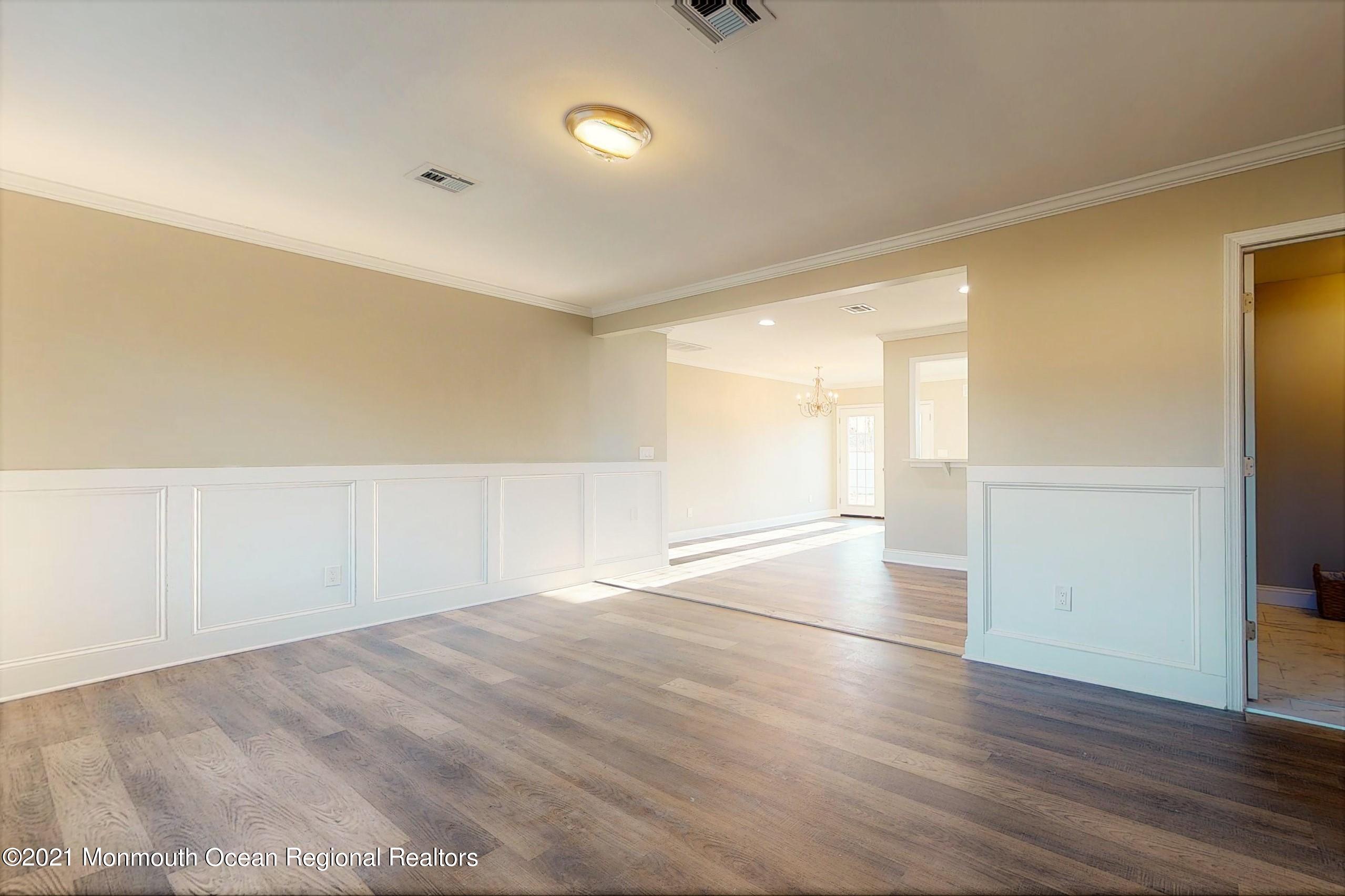 317 Stearman Road Brick, NJ 08723 - Photo 12 of 41 an empty room with wooden floor and windows