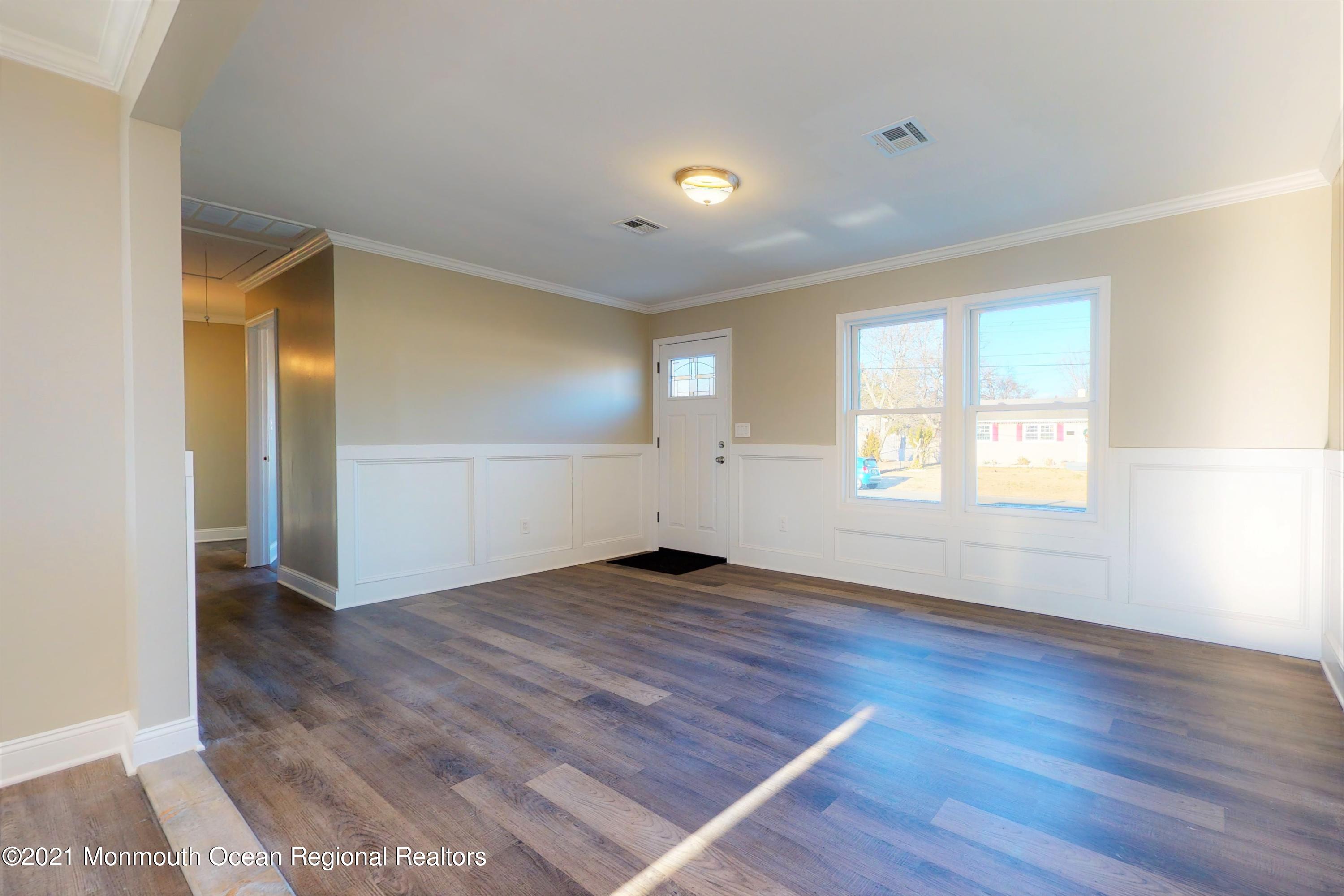 317 Stearman Road Brick, NJ 08723 - Photo 15 of 41 an empty room with wooden floor and windows