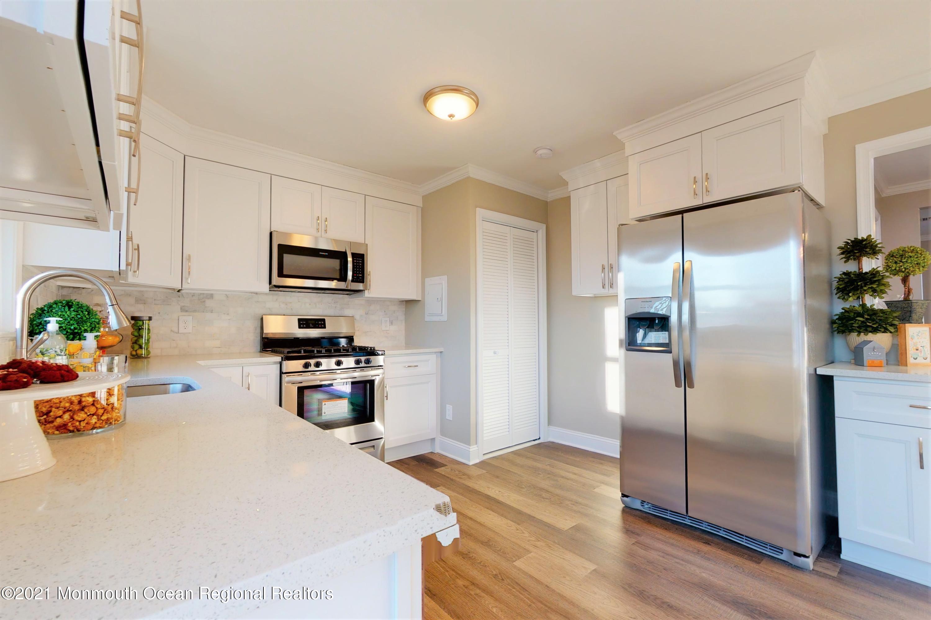317 Stearman Road Brick, NJ 08723 - Photo 18 of 41 a kitchen with kitchen island a counter top space cabinets stainless steel appliances and a window