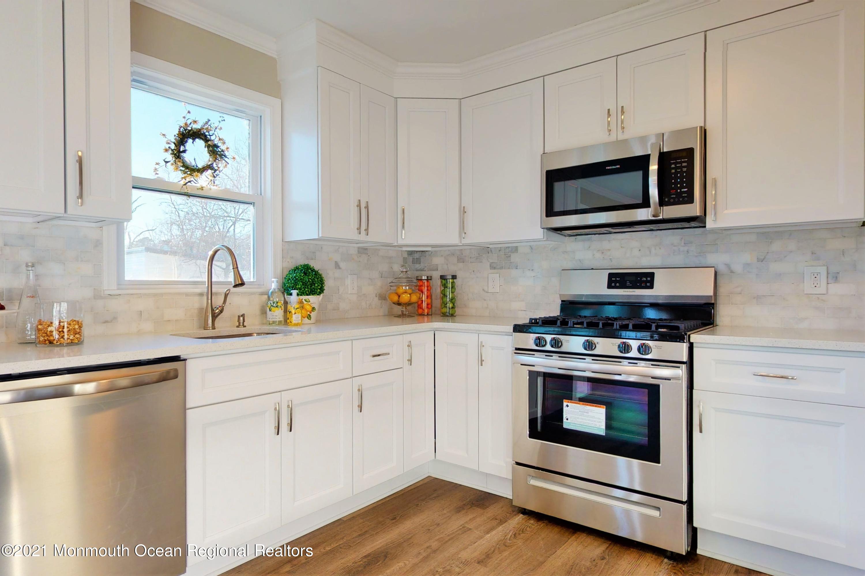 317 Stearman Road Brick, NJ 08723 - Photo 21 of 41 a kitchen with cabinets stainless steel appliances and a sink