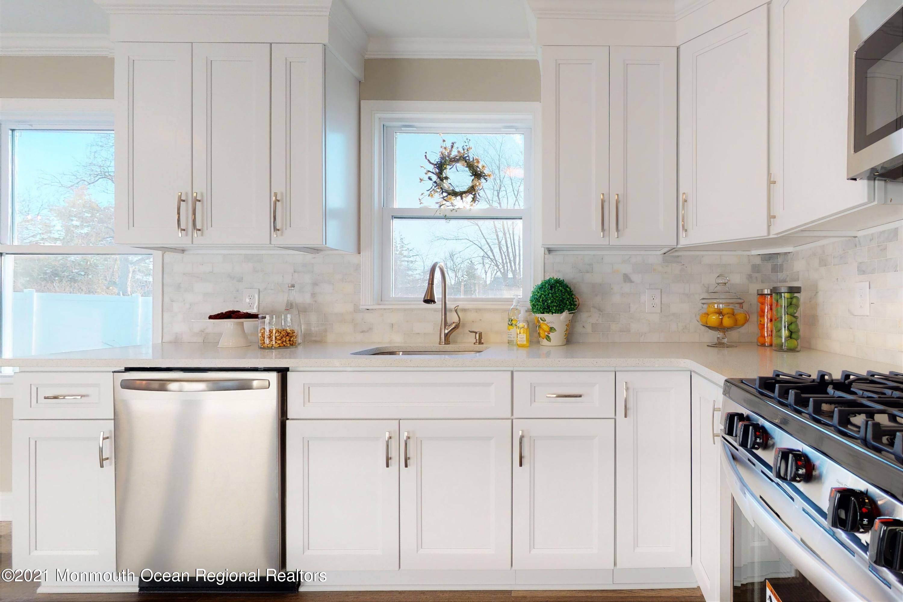 317 Stearman Road Brick, NJ 08723 - Photo 22 of 41 a kitchen with stainless steel appliances white cabinets and a stove