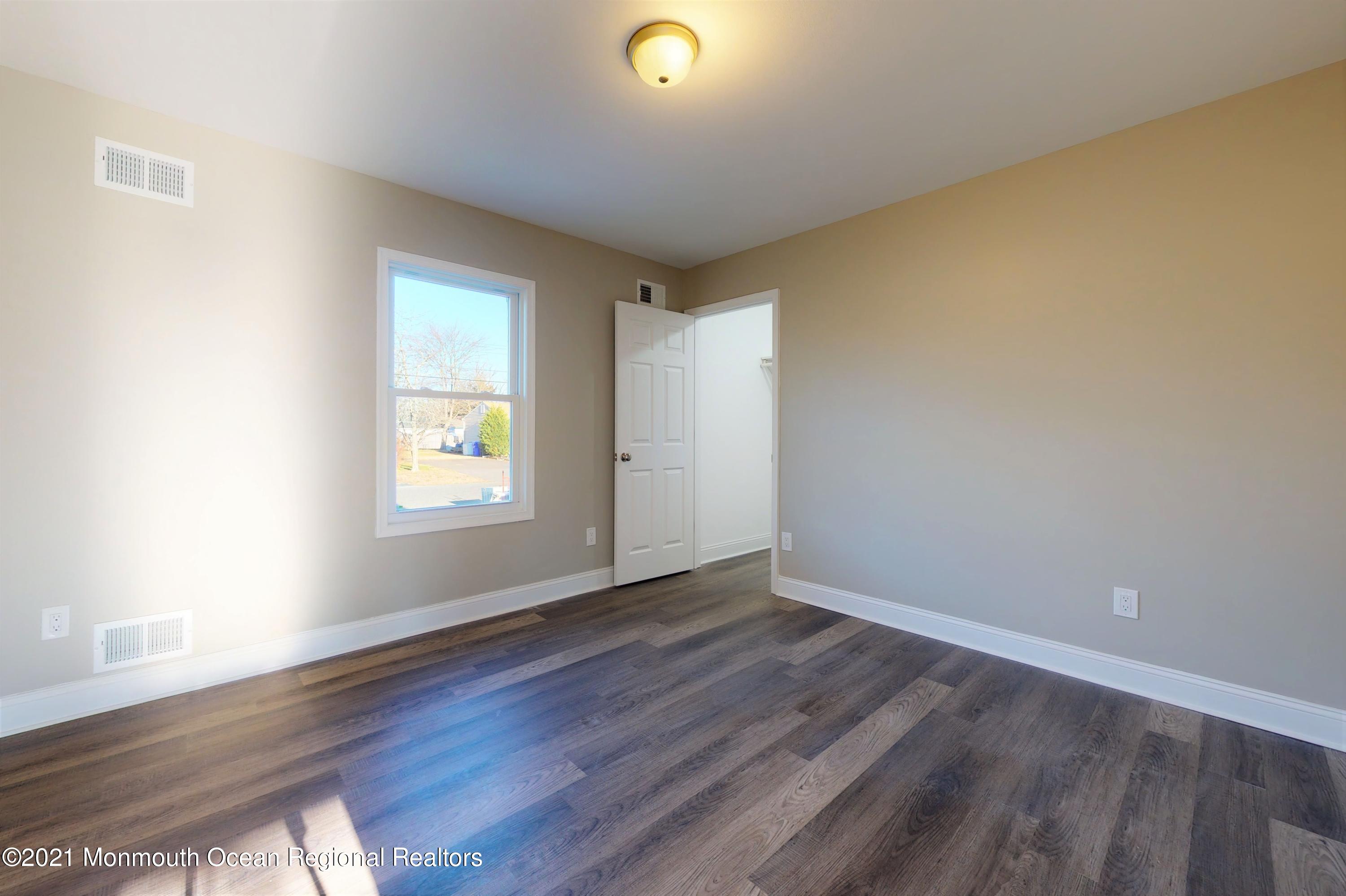 317 Stearman Road Brick, NJ 08723 - Photo 25 of 41 an empty room with wooden floor and windows