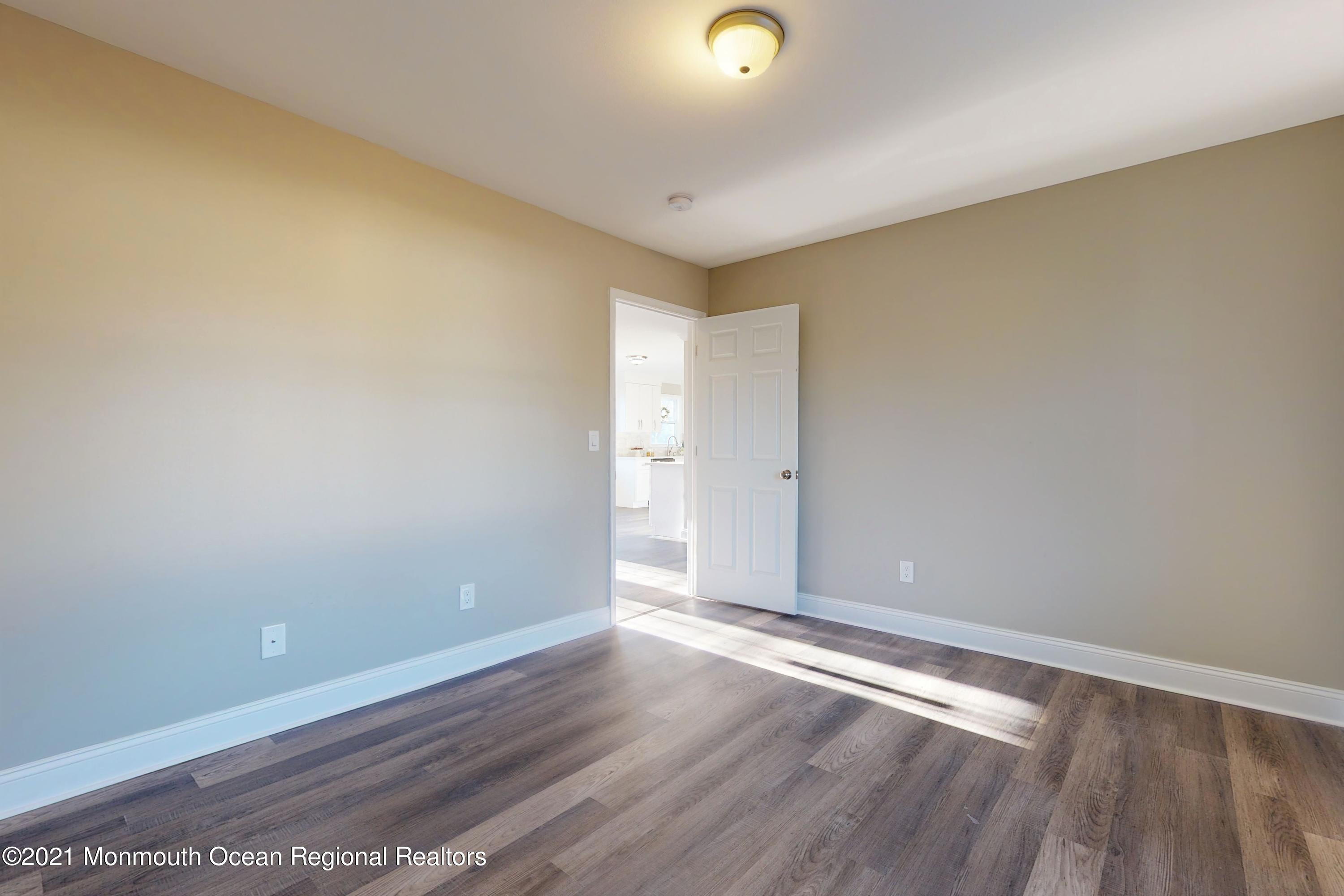 317 Stearman Road Brick, NJ 08723 - Photo 27 of 41 an empty room with wooden floor and windows