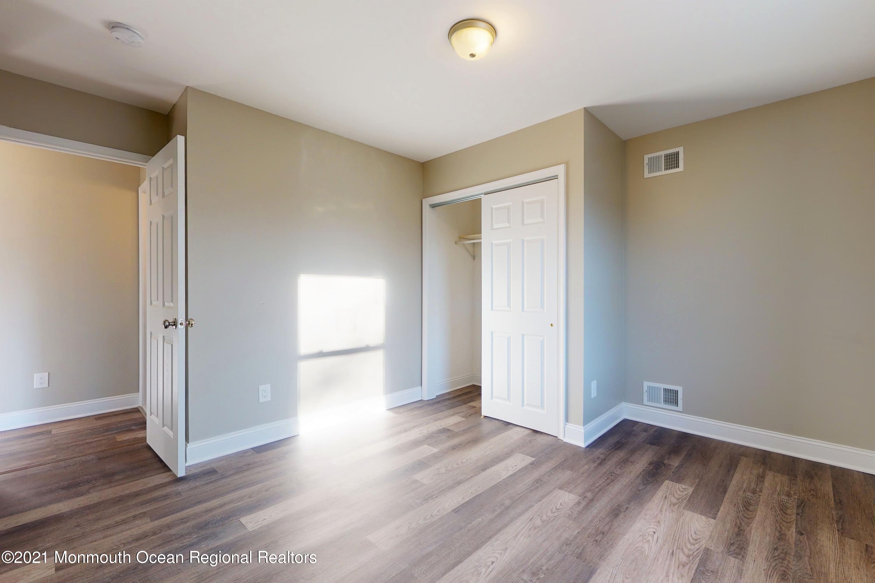 317 Stearman Road Brick, NJ 08723 - Photo 29 of 41 an empty room with wooden floor and windows