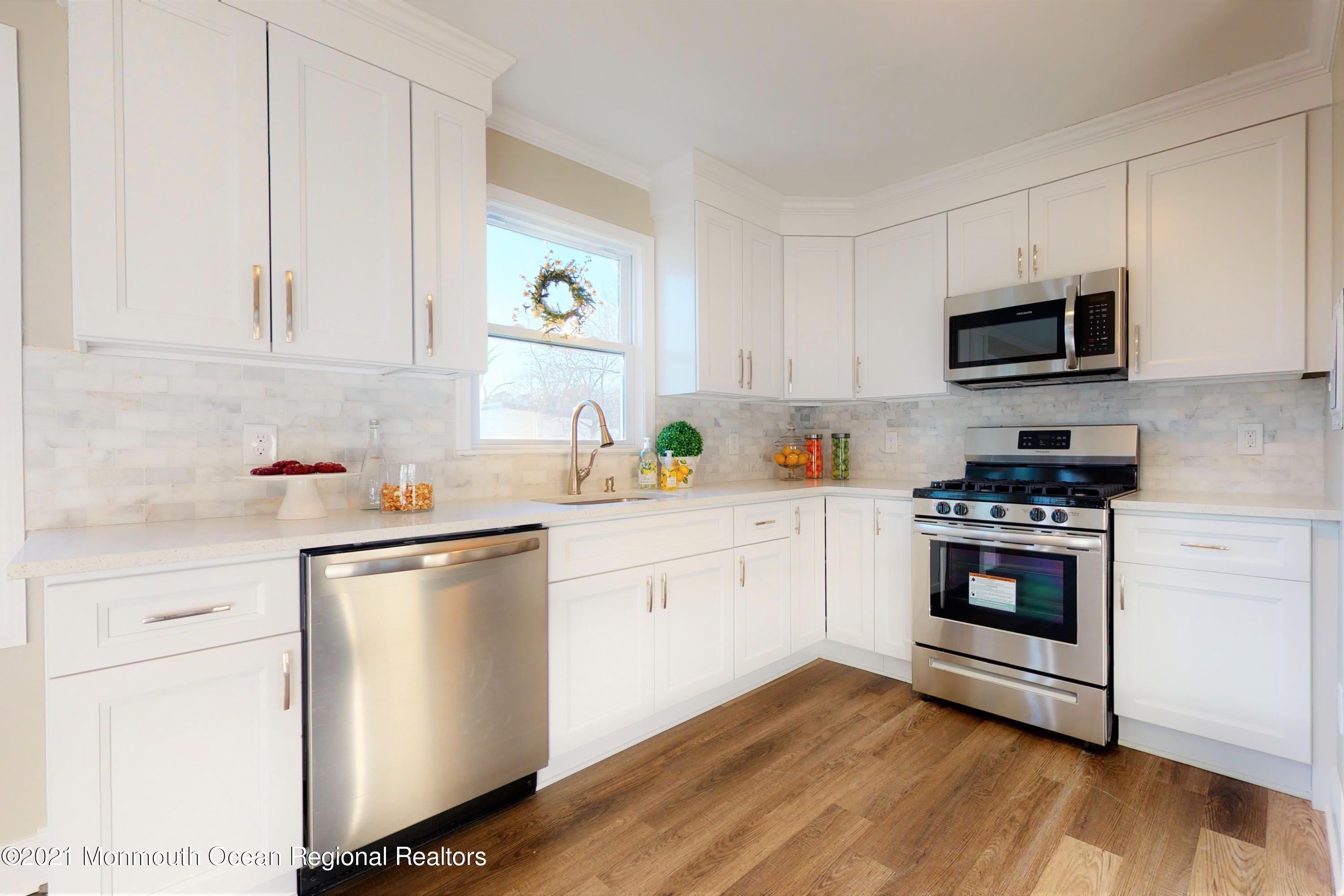 317 Stearman Road Brick, NJ 08723 - Photo 4 of 41 a kitchen with stainless steel appliances white cabinets and a sink