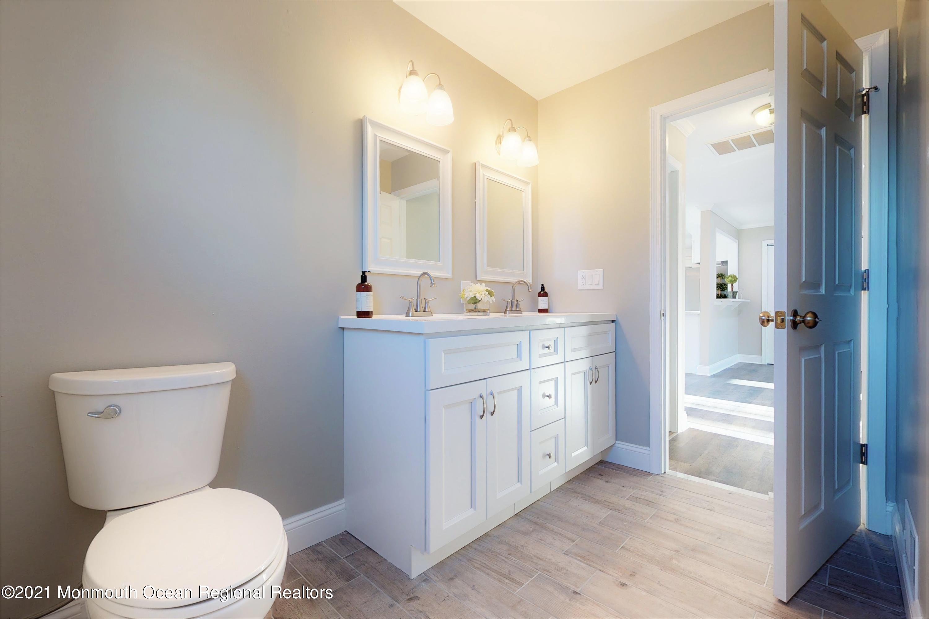 317 Stearman Road Brick, NJ 08723 - Photo 32 of 41 a bathroom with a toilet a sink and a mirror