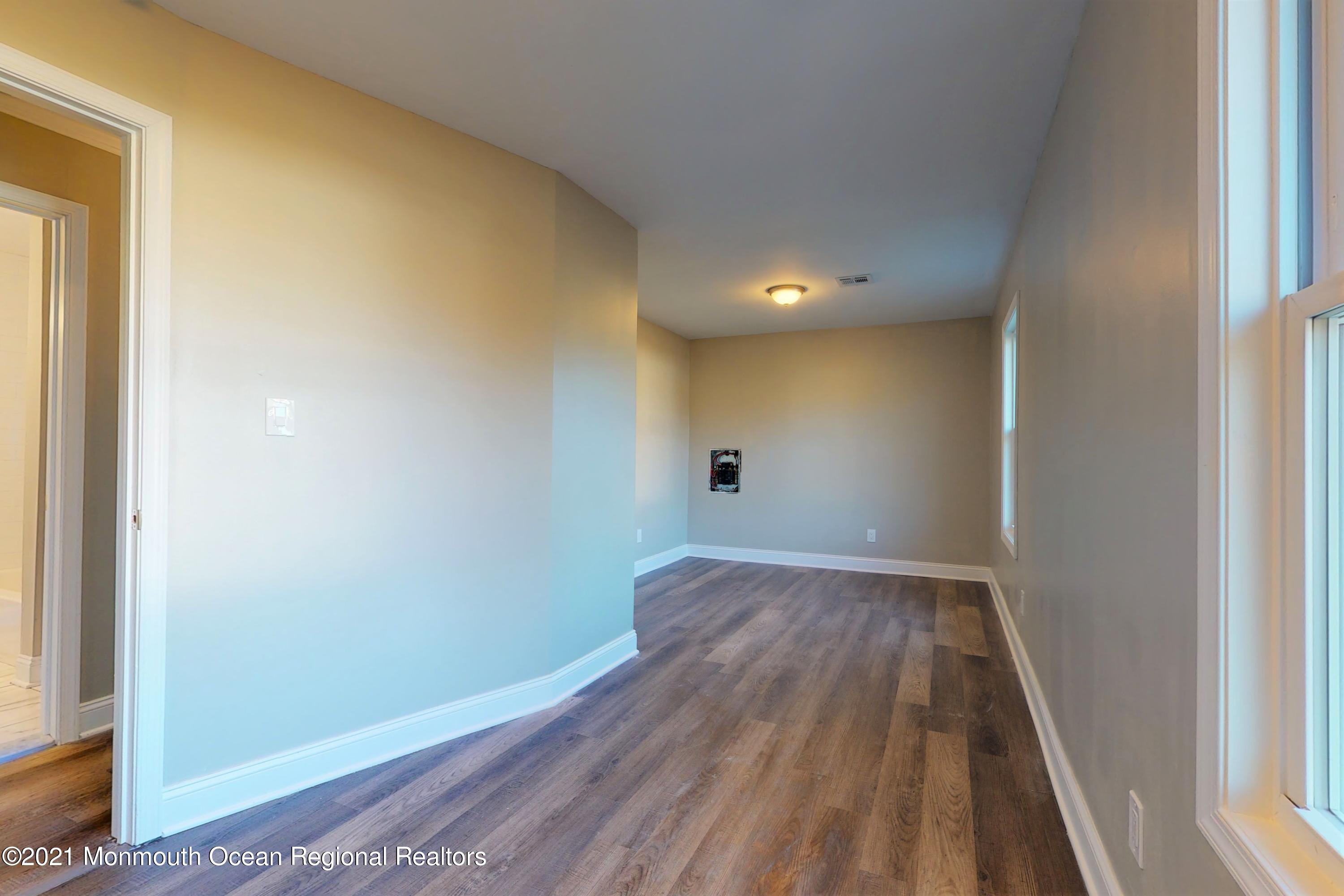 317 Stearman Road Brick, NJ 08723 - Photo 33 of 41 an empty room with wooden floor and windows