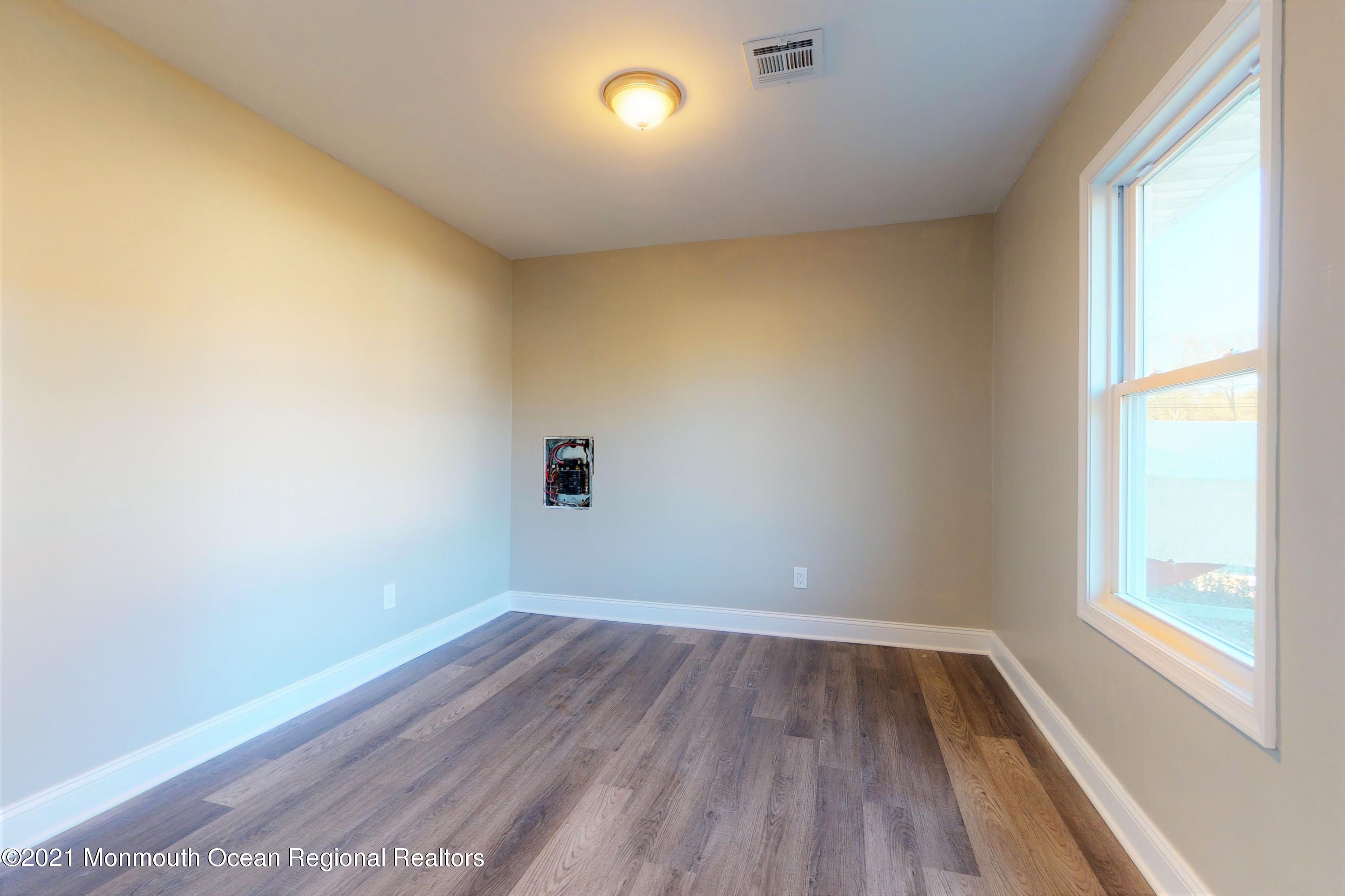 317 Stearman Road Brick, NJ 08723 - Photo 34 of 41 an empty room with wooden floor and windows