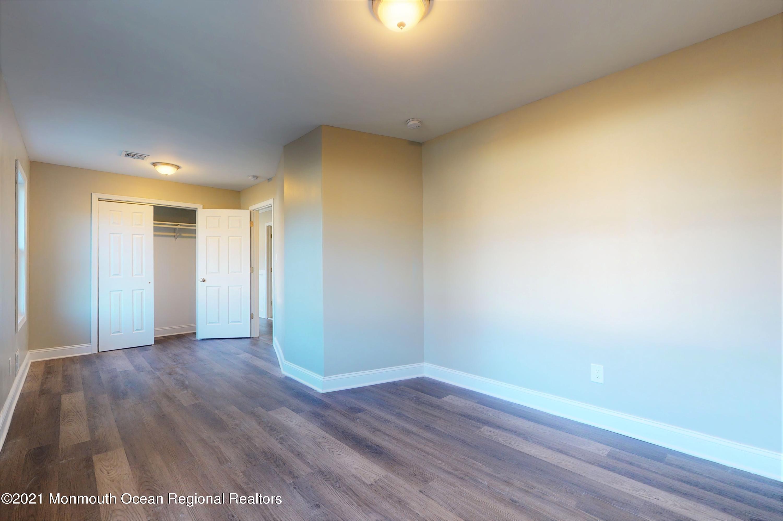 317 Stearman Road Brick, NJ 08723 - Photo 35 of 41 a view of a big room with wooden floor and windows