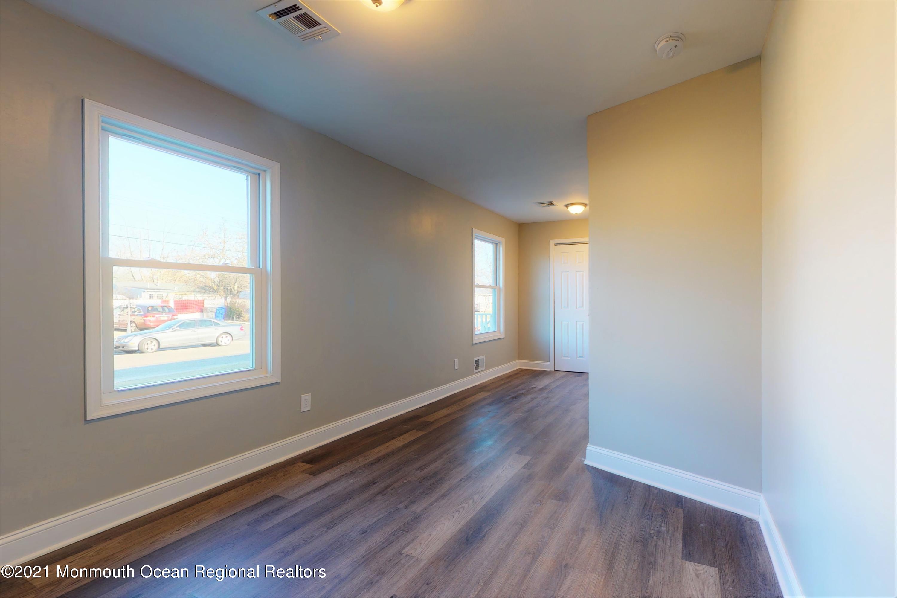 317 Stearman Road Brick, NJ 08723 - Photo 36 of 41 a view of an empty room with wooden floor and a window