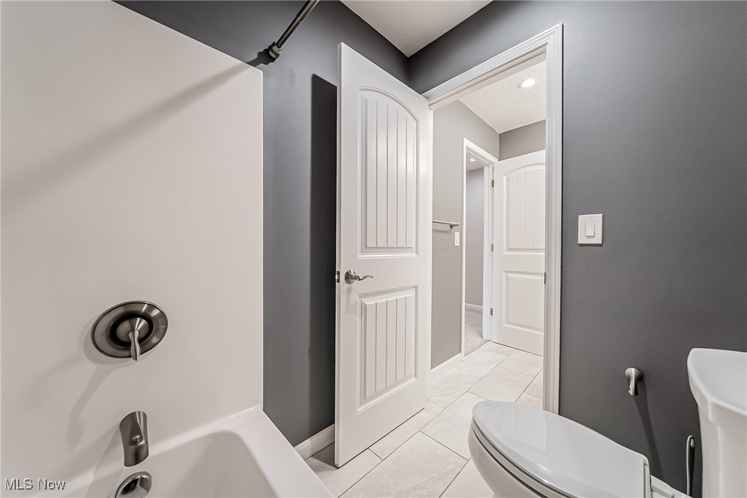 5270 Brainard Road Solon, OH 44139 - Photo 17 of 45 Hall bath with light tile patterned floors and shower / tub combination