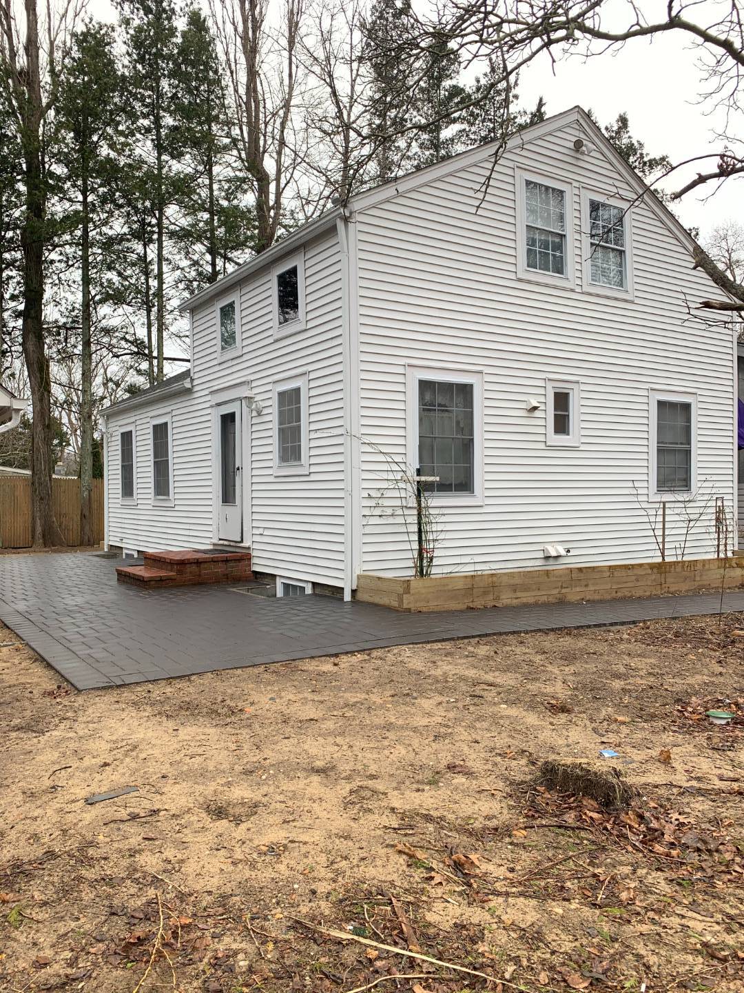 359 Three Mile Harbor Road East Hampton, NY 11937 - Photo 2 of 4 a view of a white house next to a yard with road
