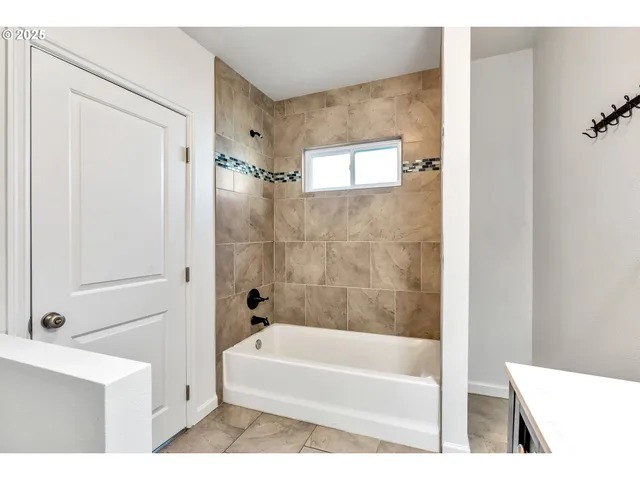 a white bath tub sitting next to a white sink