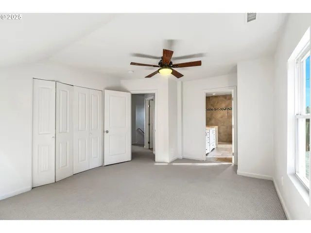 a view of empty room with ceiling fan