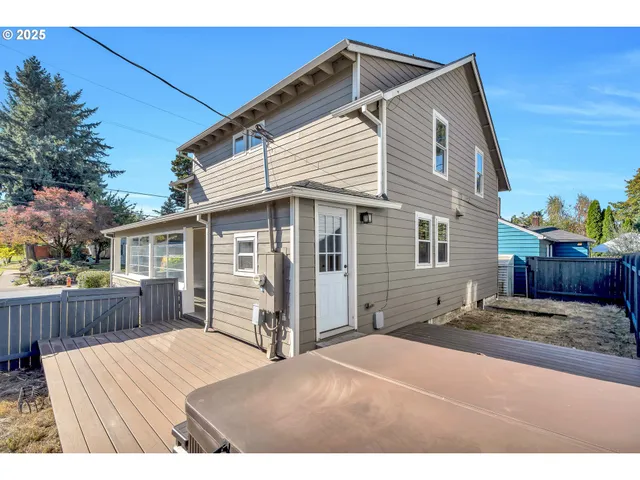 a view of a house with a yard and wooden fence