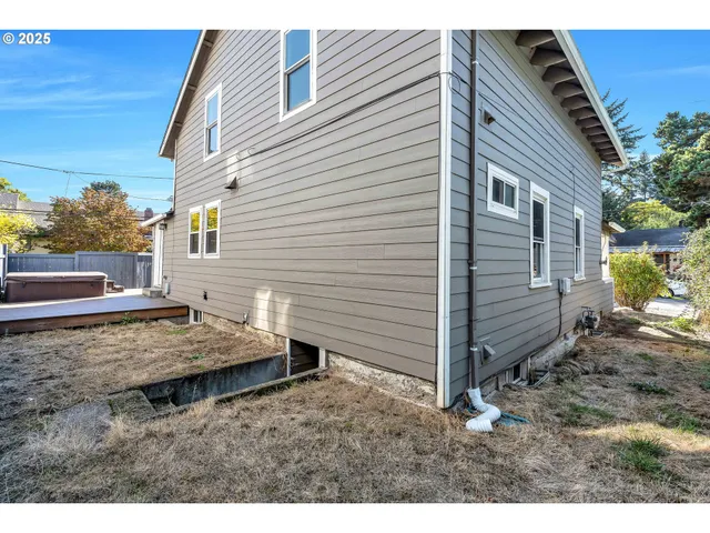 a view of a lounge chairs in the back yard of the house