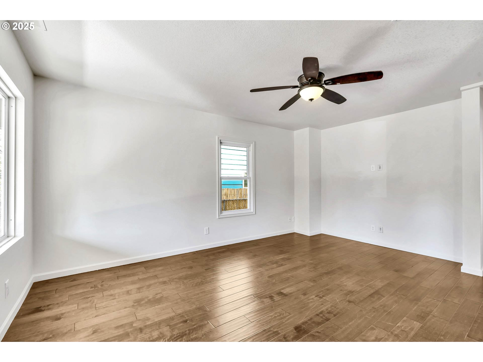 1307 North Kilpatrick Street Portland, OR 97217 - Photo 7 of 46 a view of empty room with wooden floor and fan