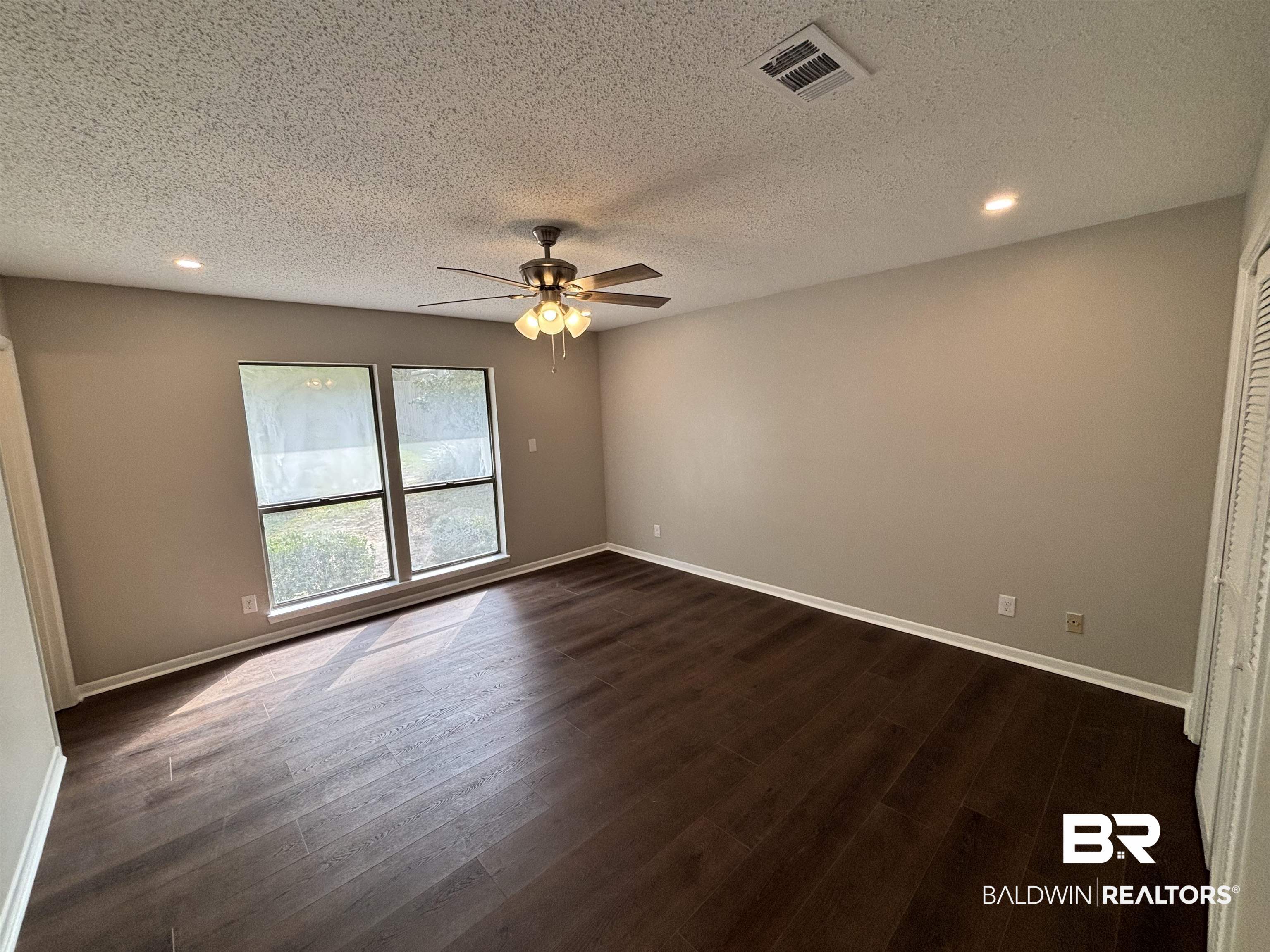 10 Soldiers Route Daphne, AL 36527 - Photo 17 of 26 Empty room featuring recessed lighting, dark wood-type flooring, a textured ceiling, and a ceiling fan