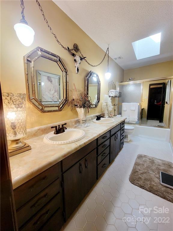 2211 Camden Road Wingate, NC 28174 - Photo 3 of 21 a spacious bathroom with a double vanity sink and a mirror