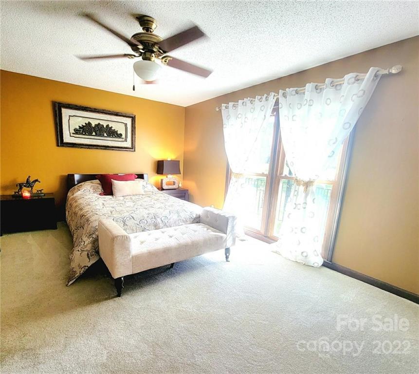 2211 Camden Road Wingate, NC 28174 - Photo 5 of 21 a bedroom with a bed and a large window