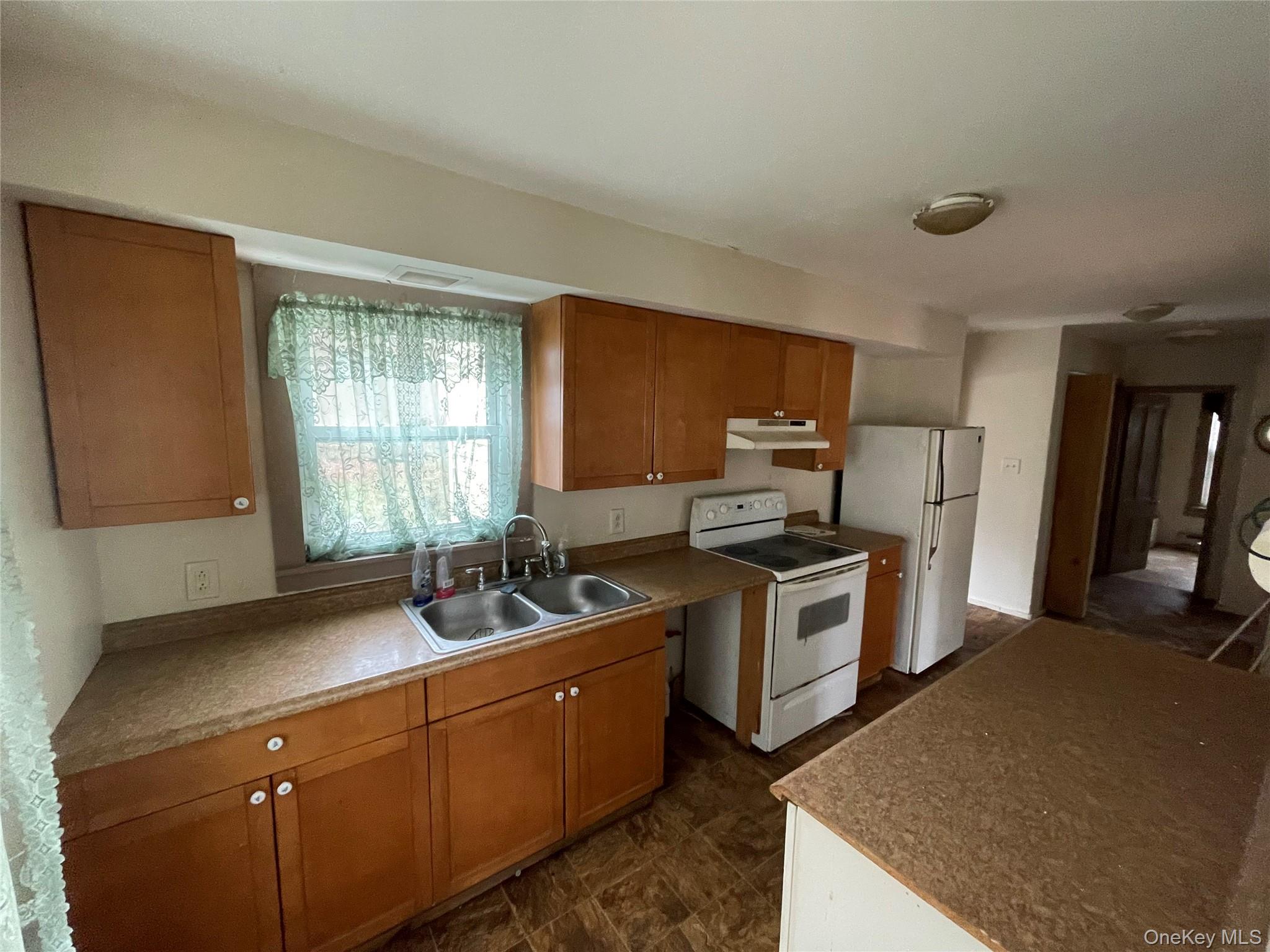 865 North Branch Road Callicoon, NY 12766 - Photo 3 of 15 Kitchen featuring white appliances, brown cabinets, and under cabinet range hood