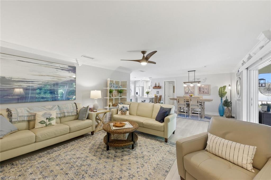 500 Teryl Road, Unit 2312 Naples, FL 34112 - Photo 12 of 46 Living area featuring ceiling fan, crown molding, and wood finished floors
