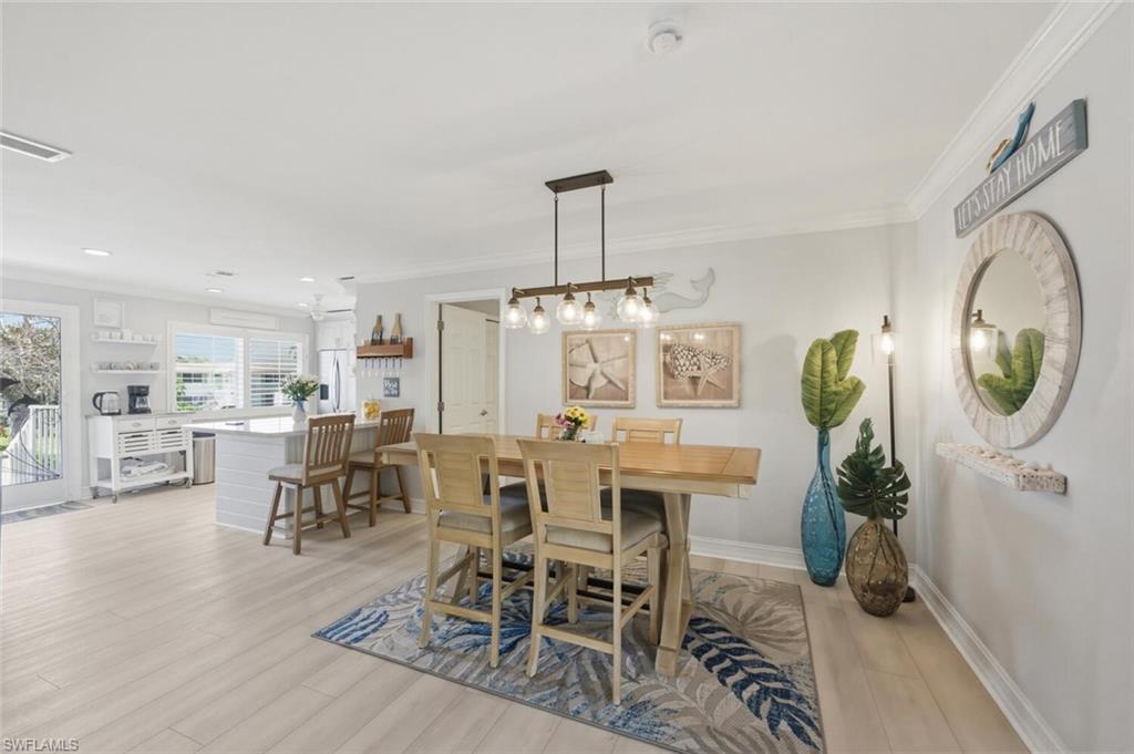 500 Teryl Road, Unit 2312 Naples, FL 34112 - Photo 15 of 46 Dining space with crown molding and light wood-type flooring