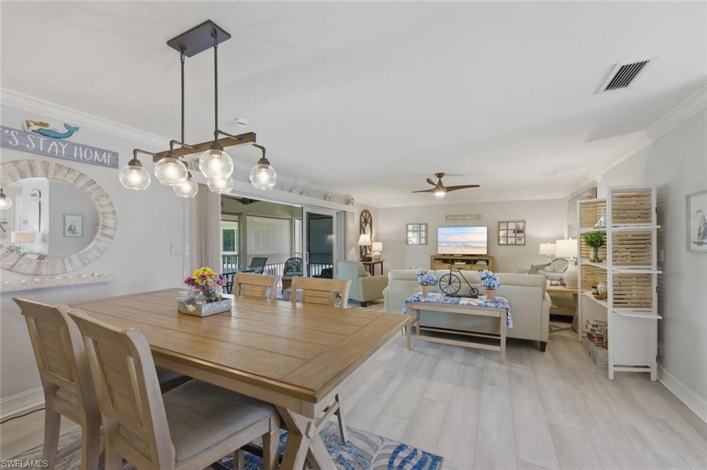 500 Teryl Road, Unit 2312 Naples, FL 34112 - Photo 16 of 46 Dining space featuring crown molding, light wood-type flooring, and a ceiling fan