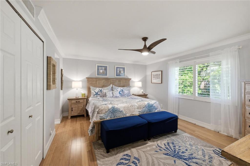 500 Teryl Road, Unit 2312 Naples, FL 34112 - Photo 17 of 46 Master Bedroom with ornamental molding, light wood-style flooring, a closet, and a ceiling fan