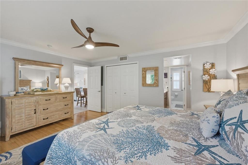500 Teryl Road, Unit 2312 Naples, FL 34112 - Photo 18 of 46 Master Bedroom with ornamental molding, light wood-style flooring, a ceiling fan, a closet, and ensuite bath