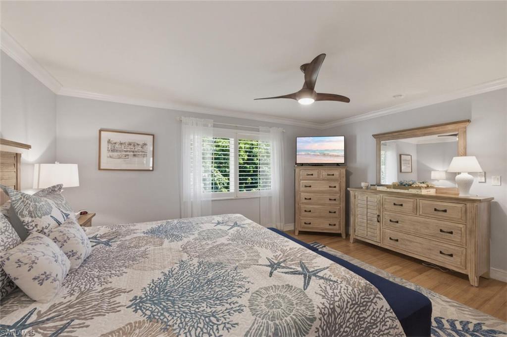 500 Teryl Road, Unit 2312 Naples, FL 34112 - Photo 19 of 46 Master Bedroom with crown molding, light wood finished floors, and ceiling fan