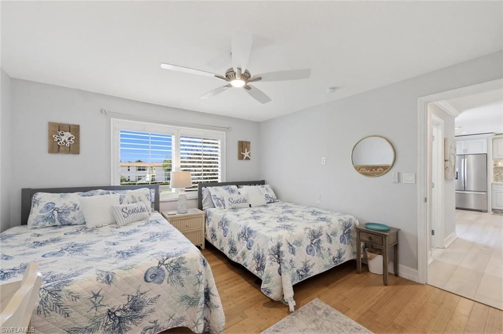 500 Teryl Road, Unit 2312 Naples, FL 34112 - Photo 24 of 46 Guest Bedroom featuring stainless steel refrigerator with ice dispenser, light wood finished floors, and a ceiling fan