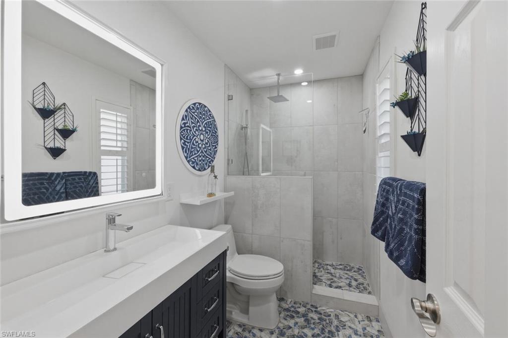 500 Teryl Road, Unit 2312 Naples, FL 34112 - Photo 25 of 46 Guest Bathroom with vanity, a walk in shower, and tile patterned flooring