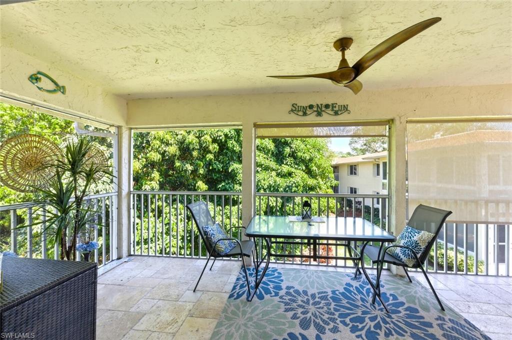 500 Teryl Road, Unit 2312 Naples, FL 34112 - Photo 26 of 46 Sunroom / solarium featuring outdoor dining area, ceiling fan, and a balcony