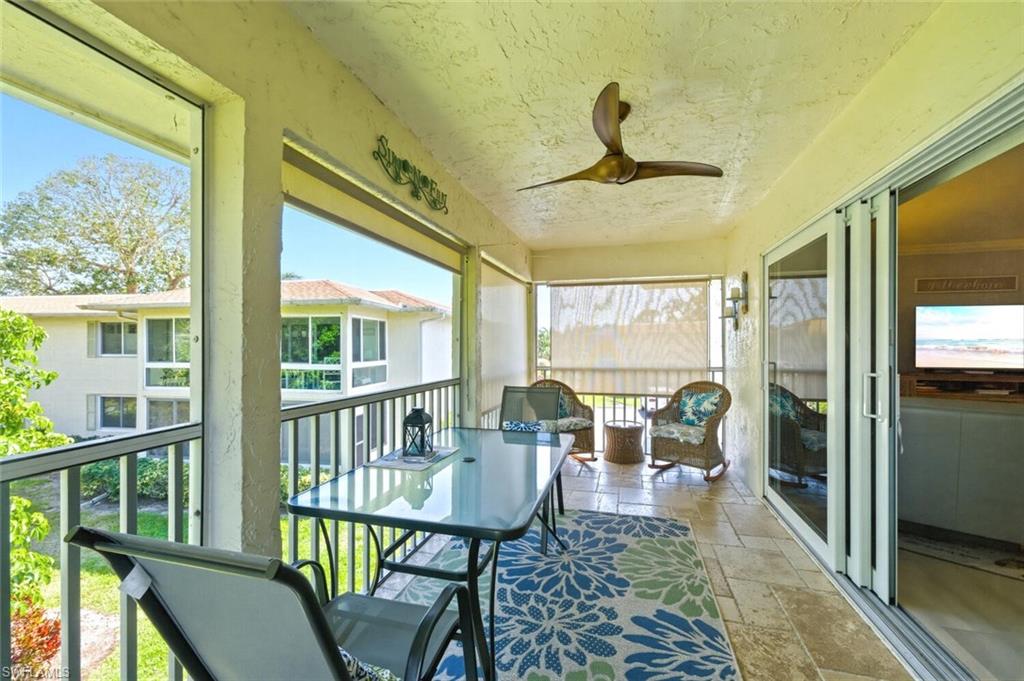 500 Teryl Road, Unit 2312 Naples, FL 34112 - Photo 27 of 46 Sunroom with a ceiling fan and a balcony