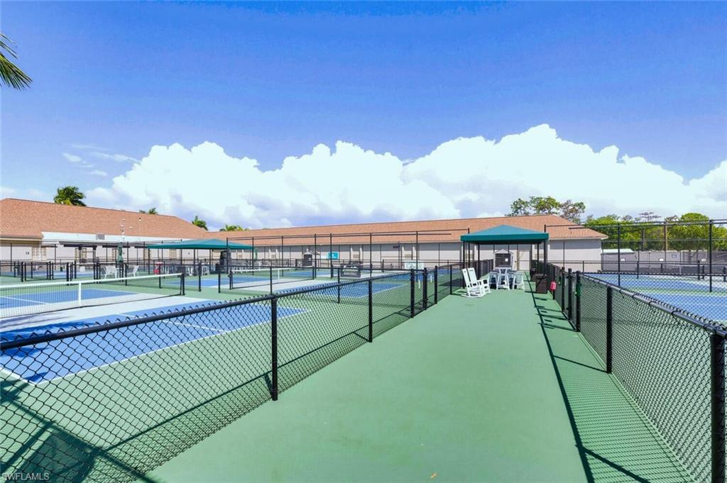 500 Teryl Road, Unit 2312 Naples, FL 34112 - Photo 39 of 46 View of tennis court featuring a patio area