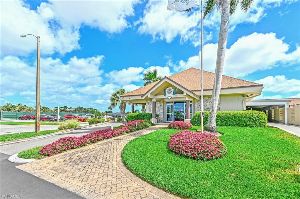 500 Teryl Road, Unit 2312 Naples, FL 34112 - Photo 40 of 46 View of front facade featuring a front lawn, a shingled roof, and stucco siding