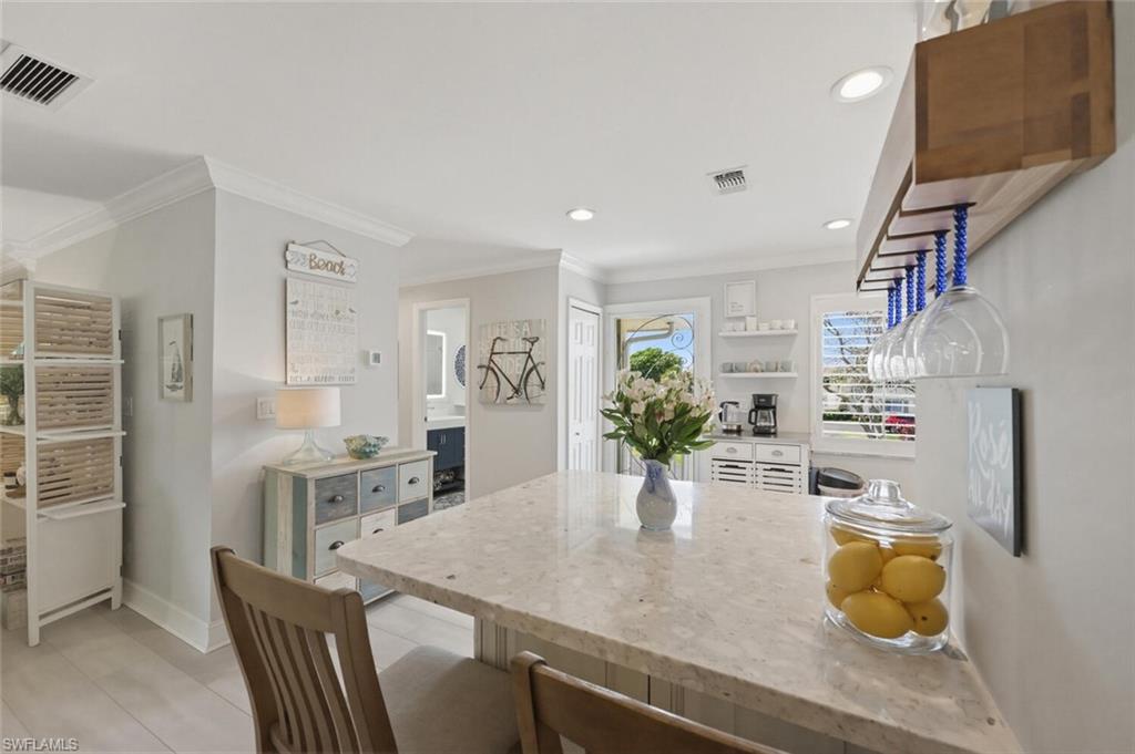 500 Teryl Road, Unit 2312 Naples, FL 34112 - Photo 4 of 46 Kitchen with a breakfast bar area, a peninsula, light stone counters, recessed lighting, and white cabinets