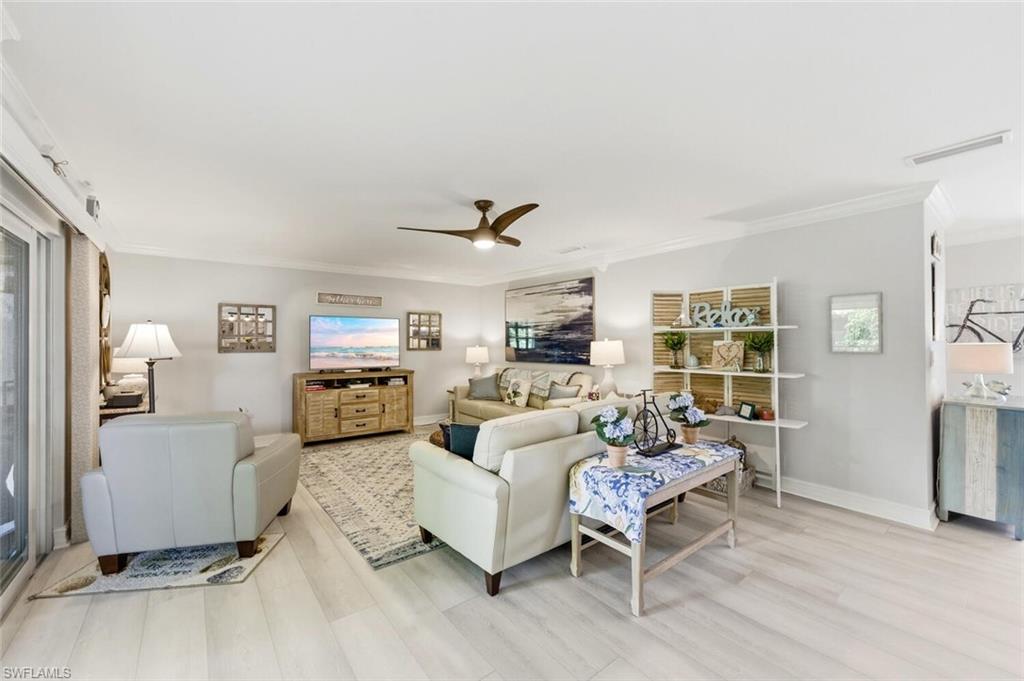 500 Teryl Road, Unit 2312 Naples, FL 34112 - Photo 9 of 46 Living room with ornamental molding, ceiling fan, and light wood-style flooring