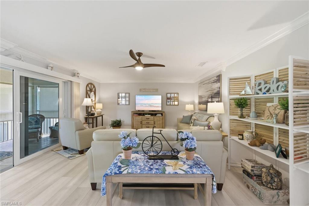 500 Teryl Road, Unit 2312 Naples, FL 34112 - Photo 10 of 46 Living room with crown molding, ceiling fan, and light wood-style flooring