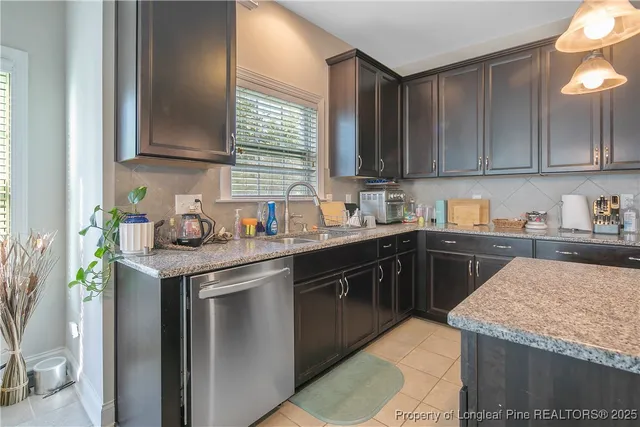 a kitchen with a sink a stove and cabinets