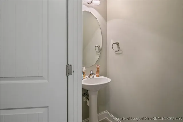 a bathroom with a sink a mirror and shower