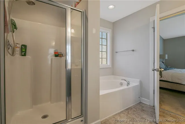 a bathroom with a tub shower and sink