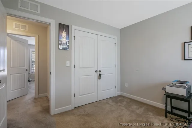 a living room with furniture a book shelf and a window