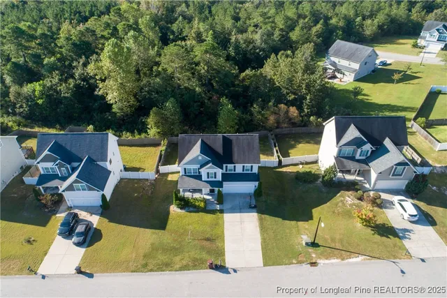an aerial view of a swimming pool with outdoor seating